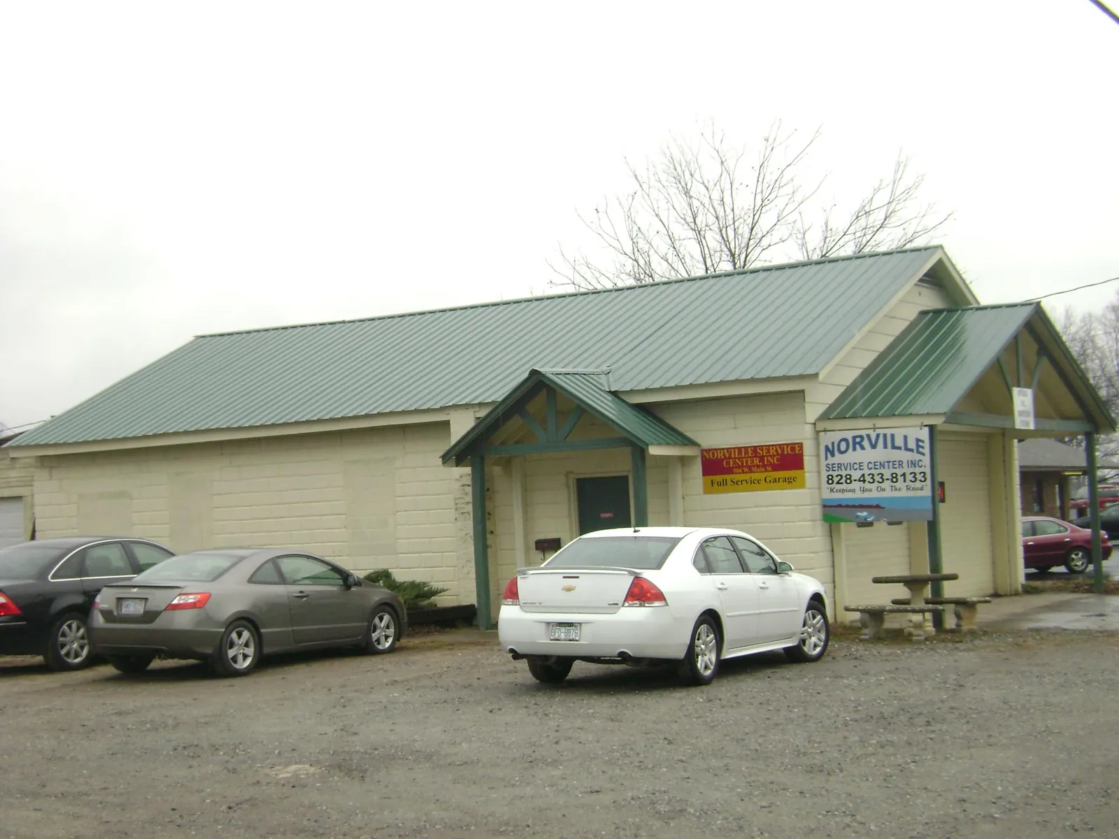 Green metal roof on a service garage with a covered entry in Gibbon Glade